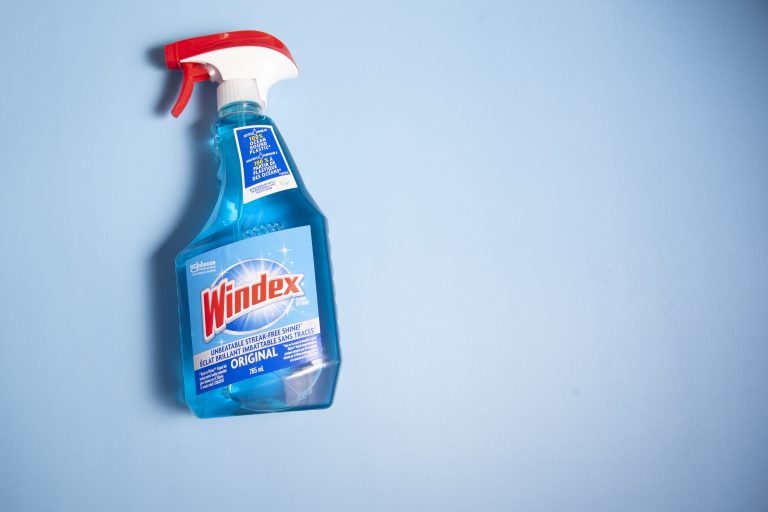 Cleaning Inside Of Windshield With Windex